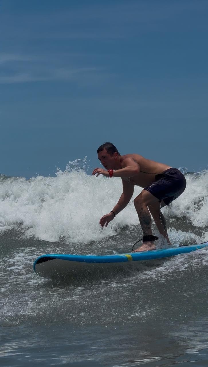 Surfer riding a blue board in Panama